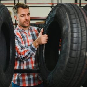 Man chooses winter car tires in the auto shop.